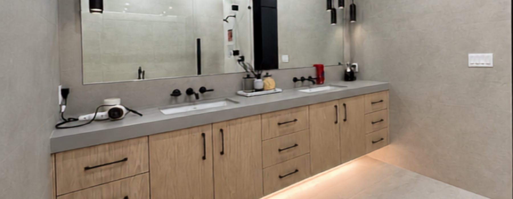 Renovated bathroom with wood vanity, double sinks and large mirror